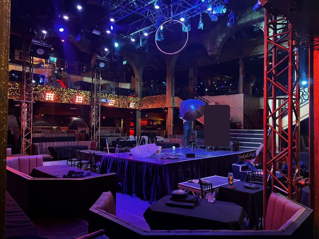 Empty nightclub stage with colorful lighting.