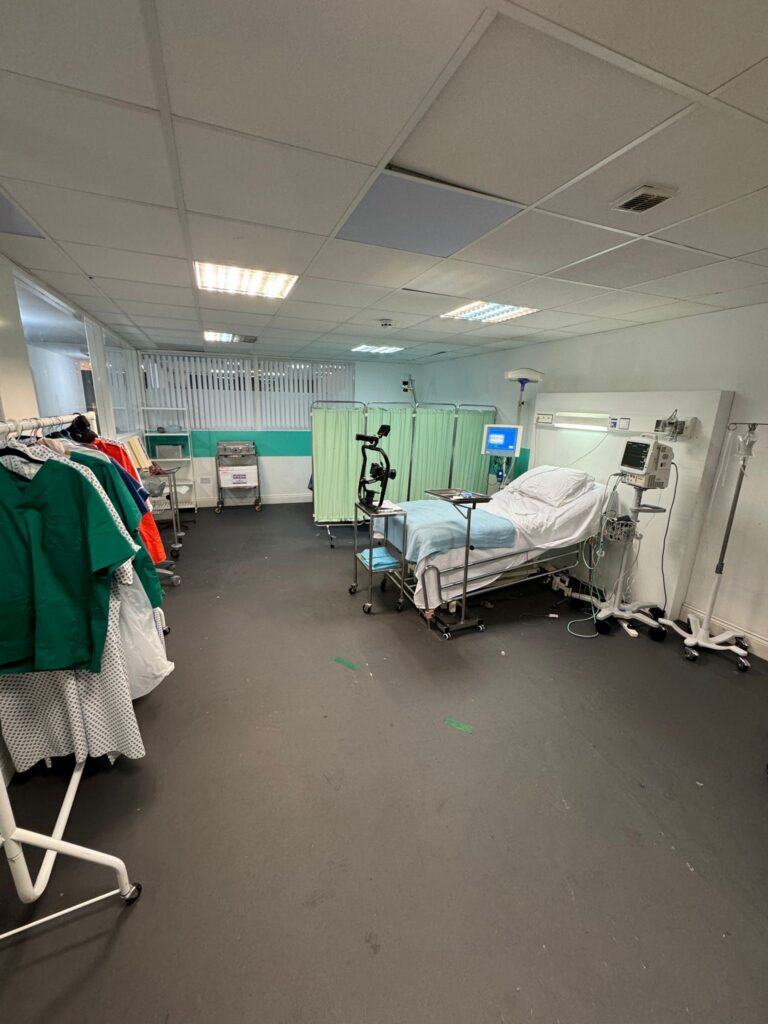 Hospital room with medical equipment and bed.