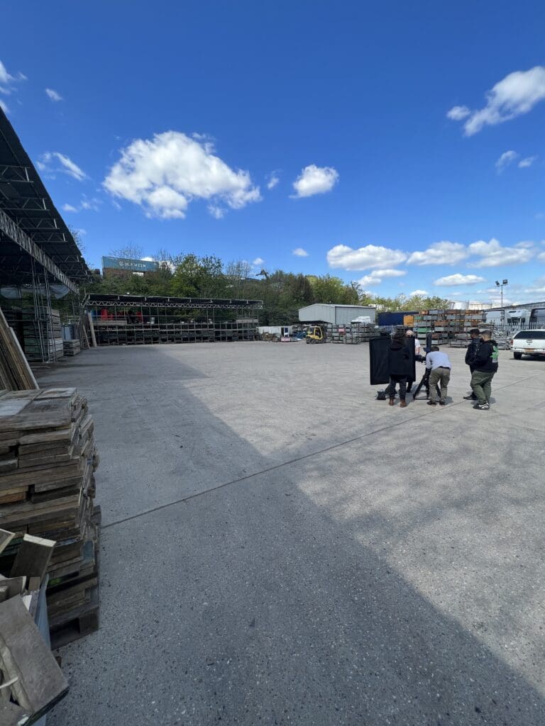 People walking in an industrial yard.