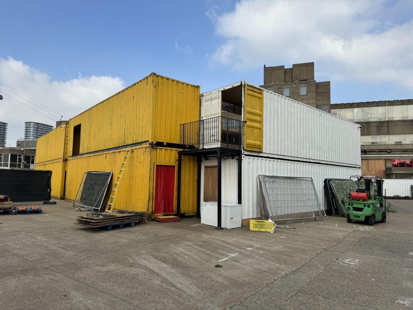 Stacked yellow and white shipping containers.