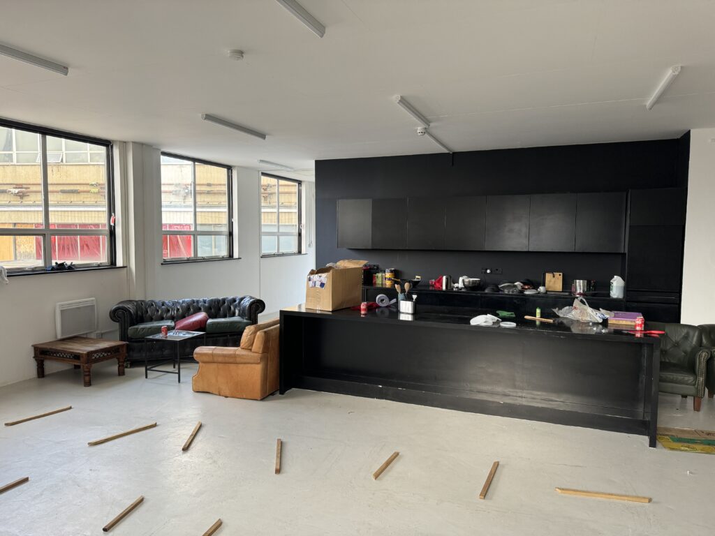 Loft interior with couches and kitchen area.