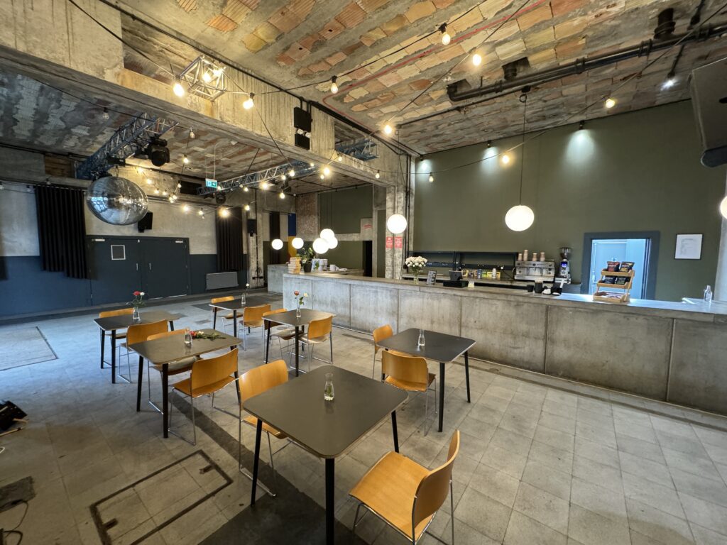 Industrial-style cafe with tables and chairs.