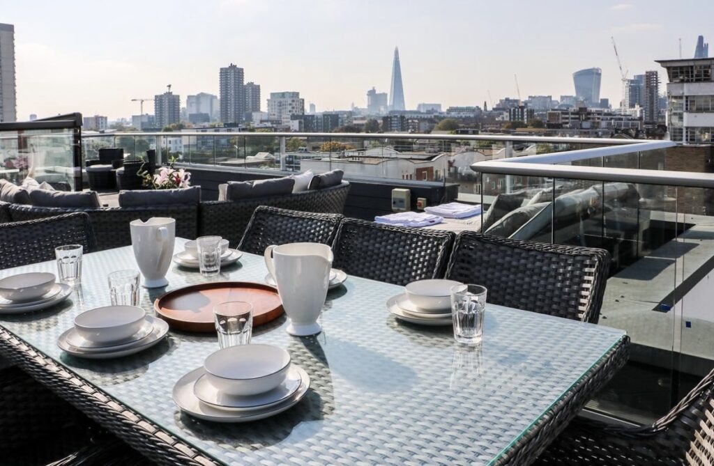 Rooftop dining with city skyline view.
