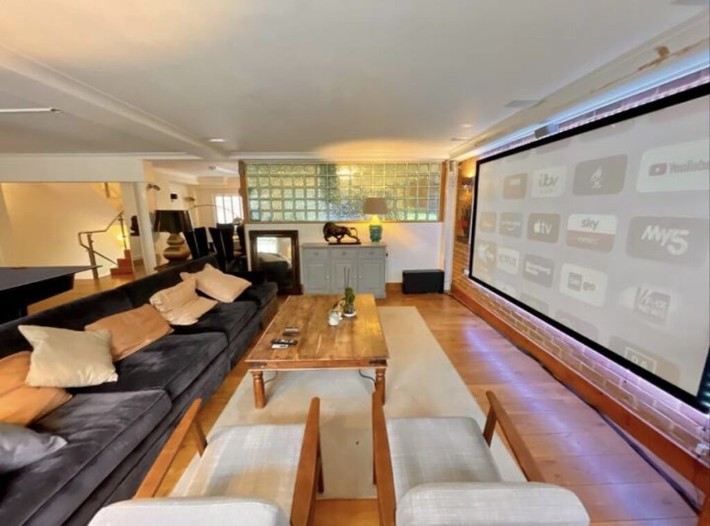 Home theater with large screen and seating.