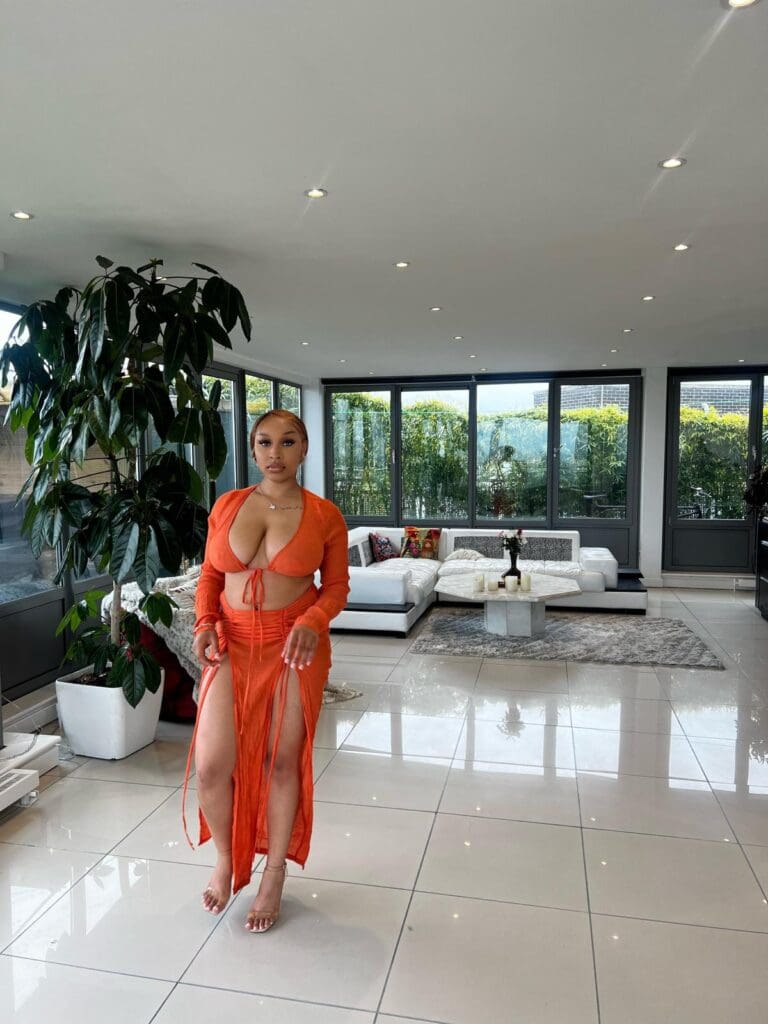 Woman in orange outfit in modern living room.