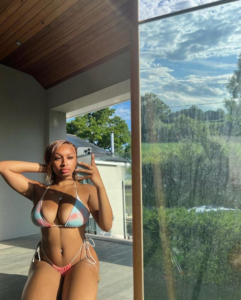 Person posing in bikini near window view.