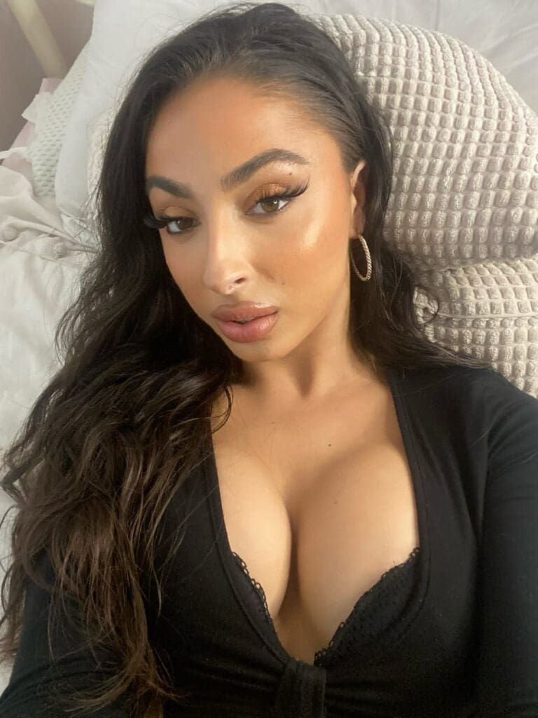 Woman lying down, wearing a black top.