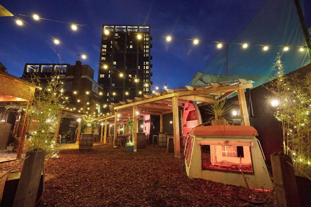 Outdoor patio with string lights at night.