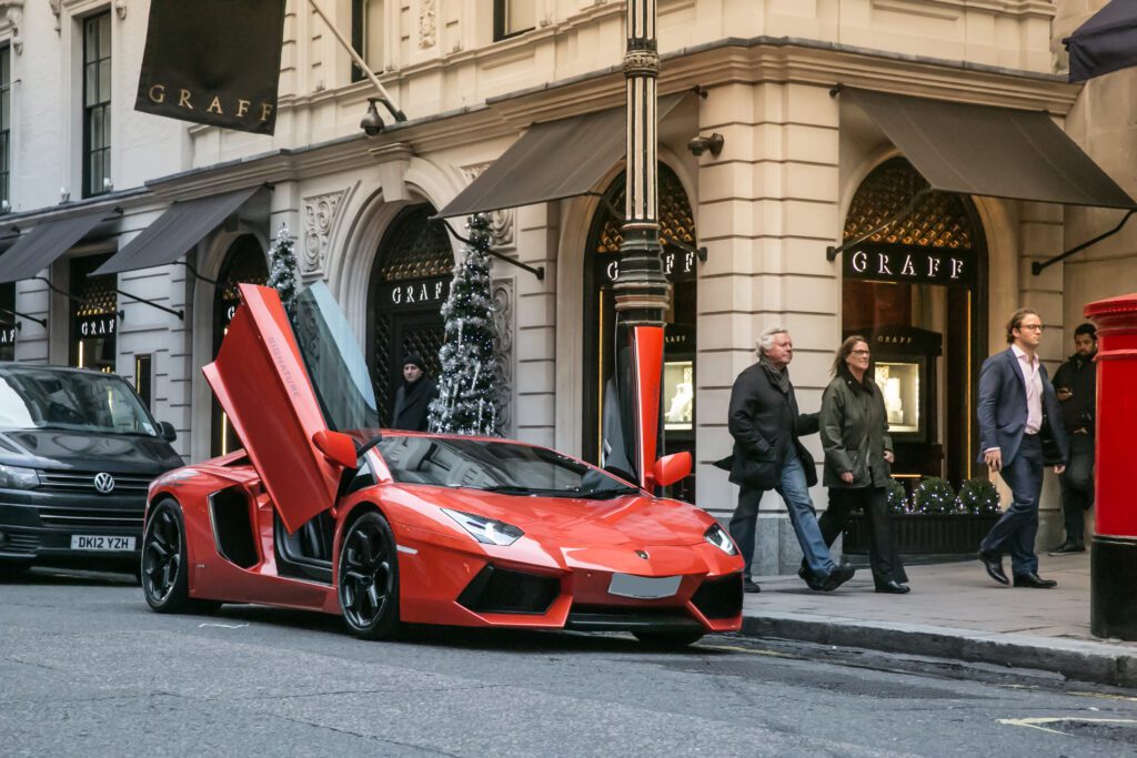 Red sports car parked on city street.