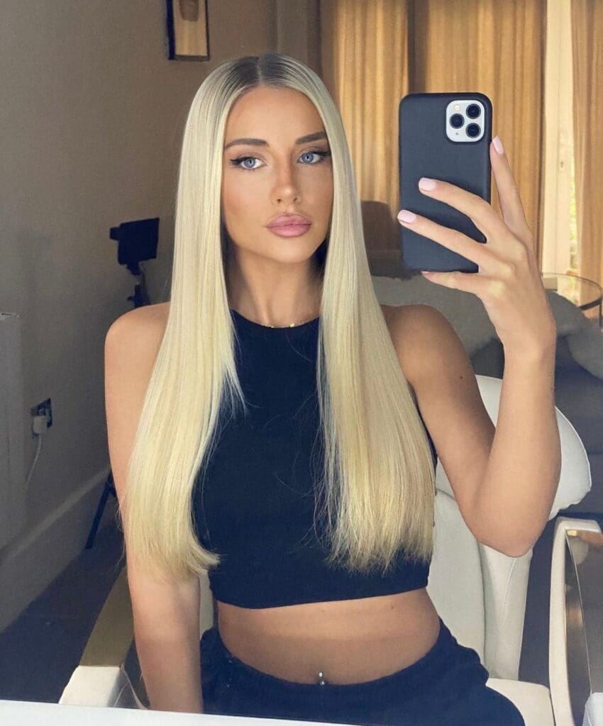 Woman taking a selfie in a mirror.