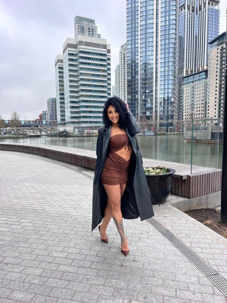 Woman in cityscape with skyscrapers and river.