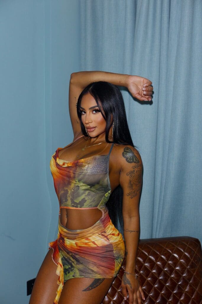 Woman posing in colorful dress indoors.