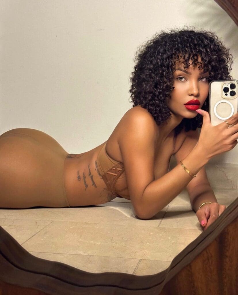 Person taking mirror selfie on the floor.