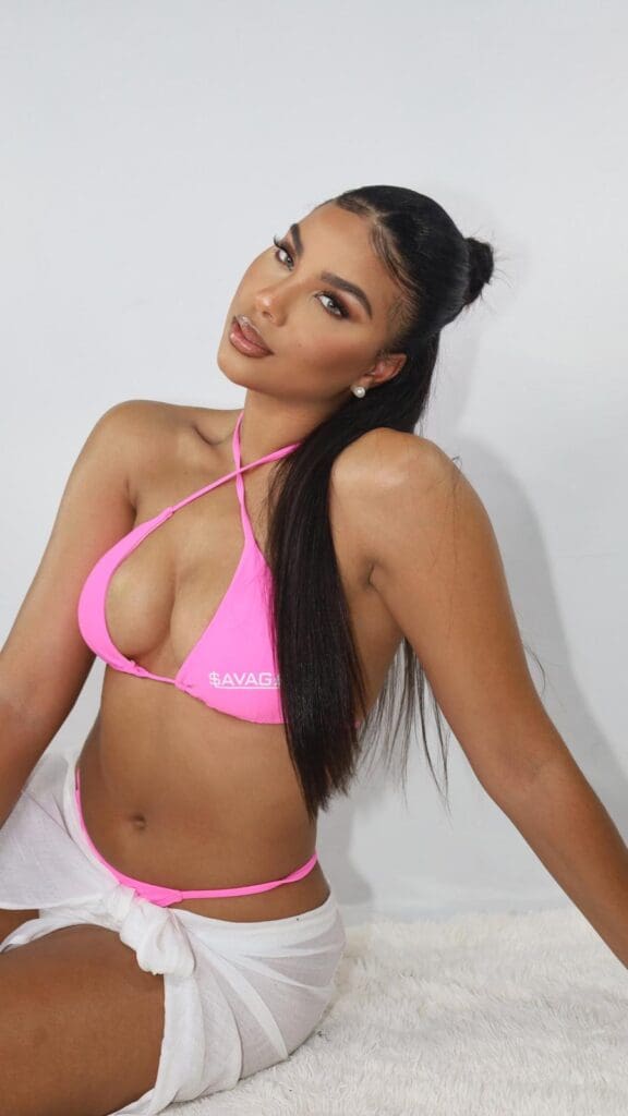 Woman in pink bikini, white wrap skirt.