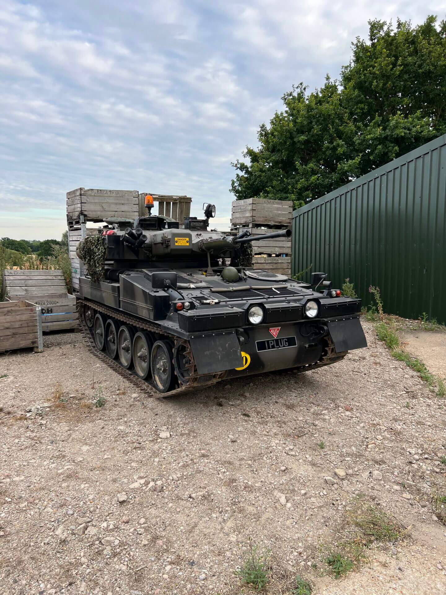 Military vehicle parked near wooden crates.