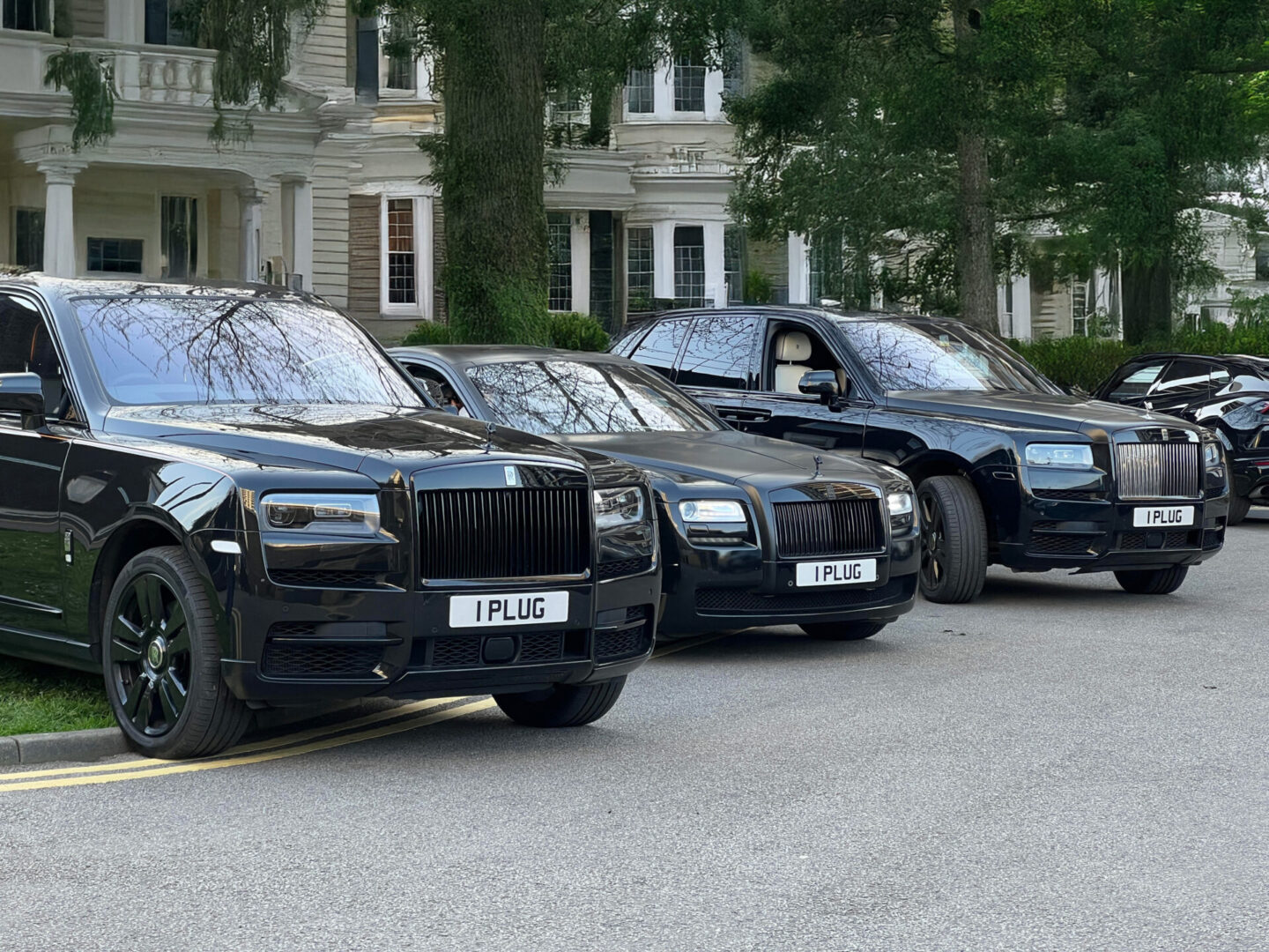 Three luxury cars parked in a row.